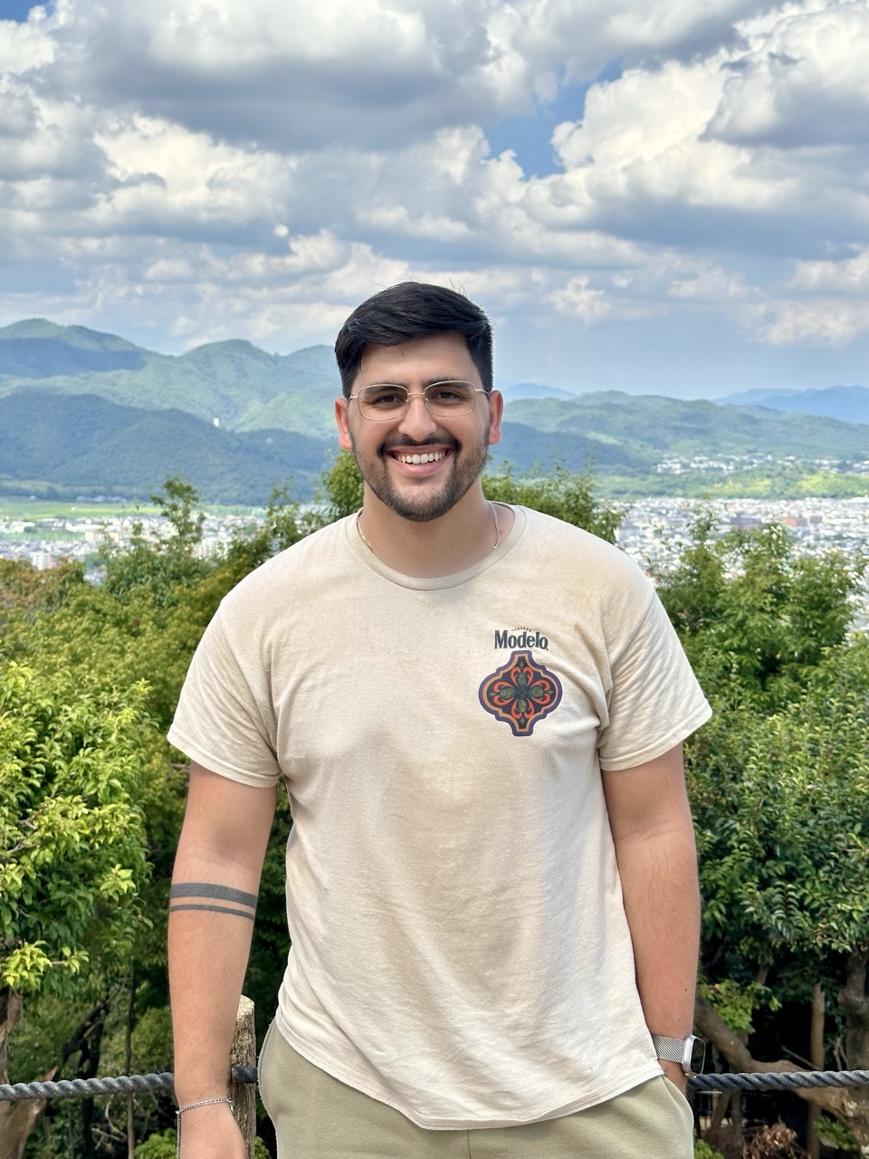 Bryan Cabrera smiling on a hillside overlooking Kyoto